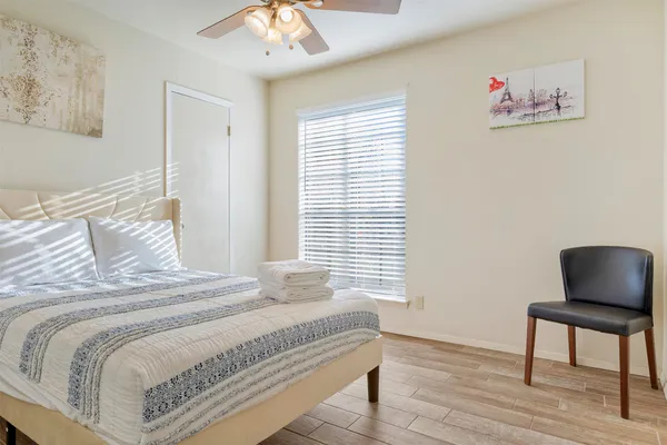 a bedroom with a bed and a wall painting