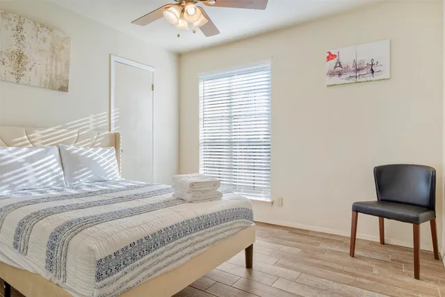 a bedroom with a bed and a wall painting