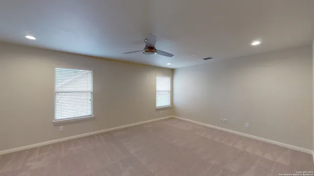 an empty room with windows and closet