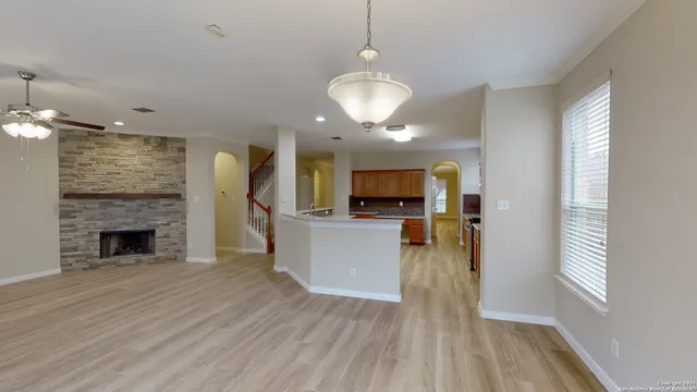 a view of living room with furniture and a fireplace