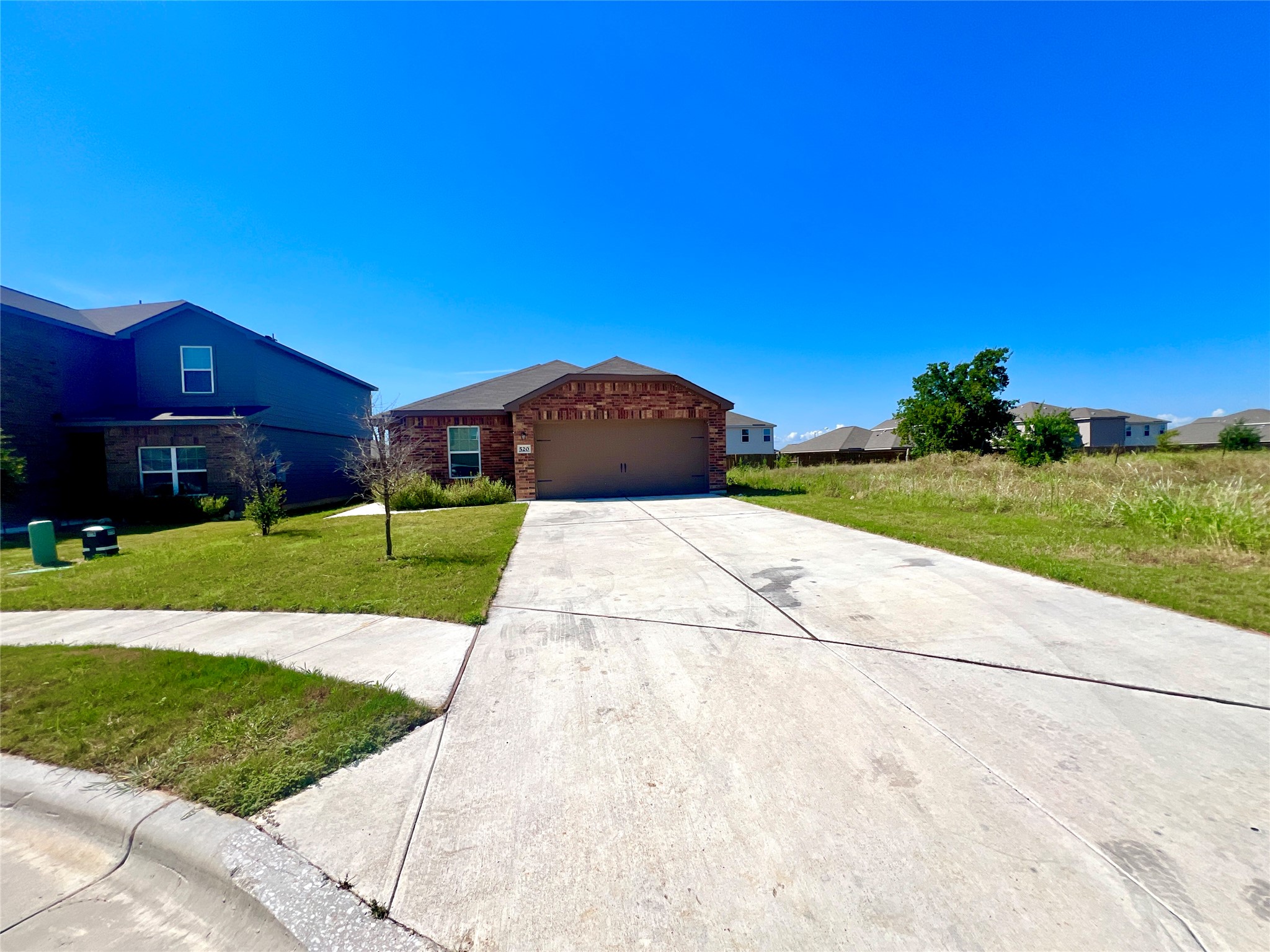 520 Locksley Cove Jarrell, TX 76537 - Photo 1 of 27 A well-maintained concrete driveway leads to this charming brick residence, offering ample parking and curb appeal.