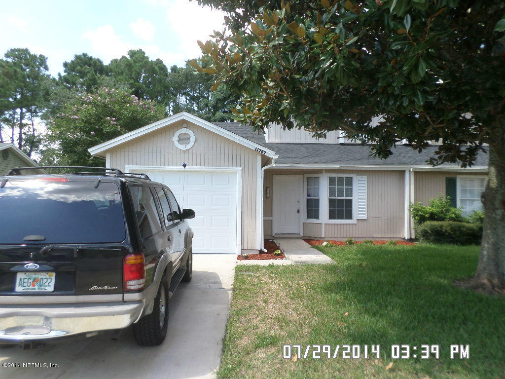 11757 Wattle Tree Road West Jacksonville, FL 32246 - Photo 1 of 5 a view of a house with a yard patio and a small yard