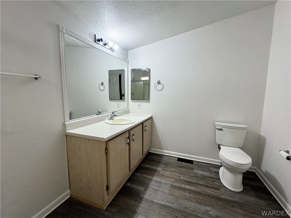 1575 South Roy Road Kingman, AZ 86401 - Photo 39 of 56 The master bathroom features a vanity with a sink, a large mirror, and a toilet