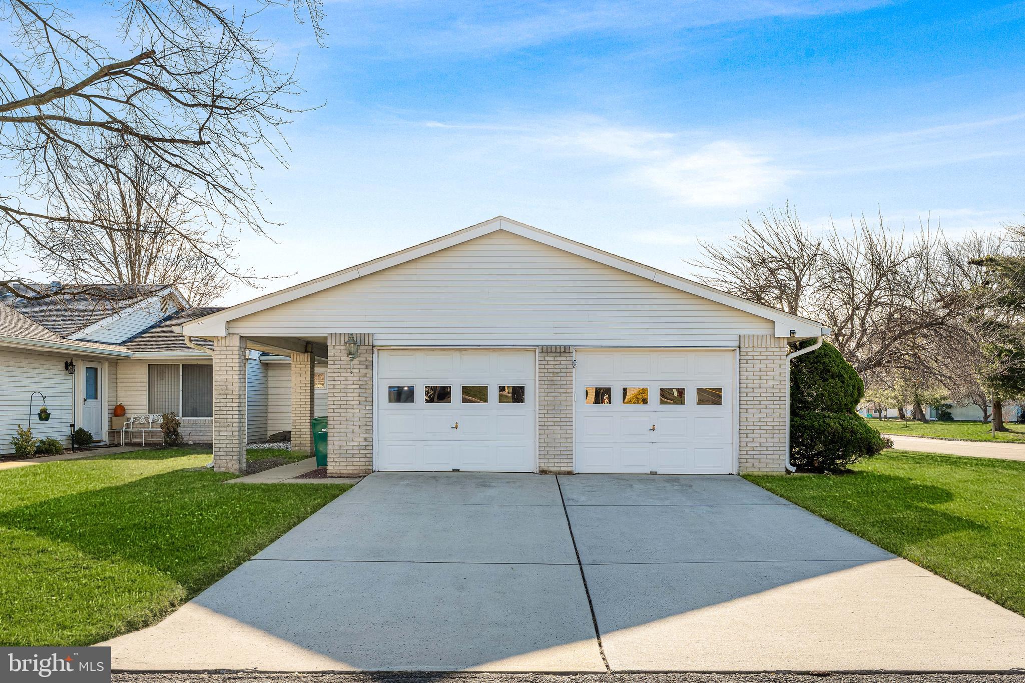 a view of a white house with a yard
