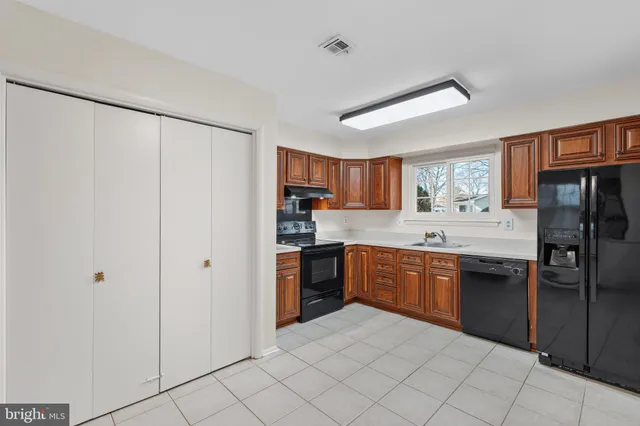 a large kitchen with cabinets and stainless steel appliances