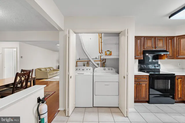 a kitchen that has a lot of cabinets in it and wooden floors