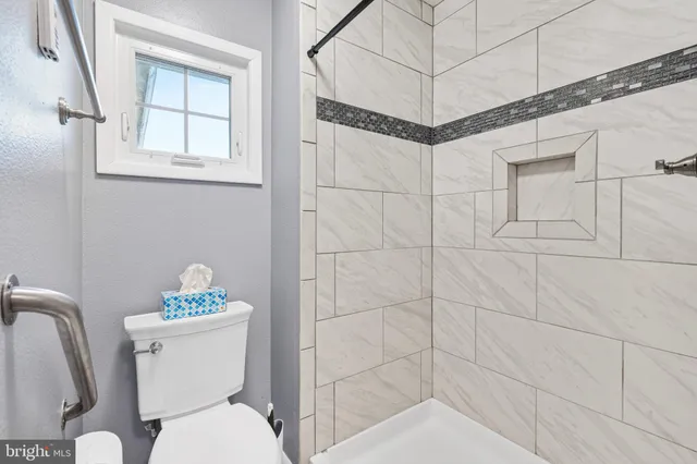a white toilet sitting next to a bathroom sink