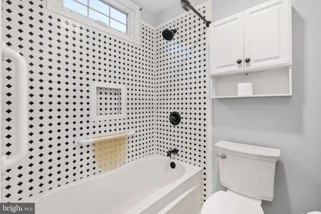 a bathroom with a toilet and a bathtub