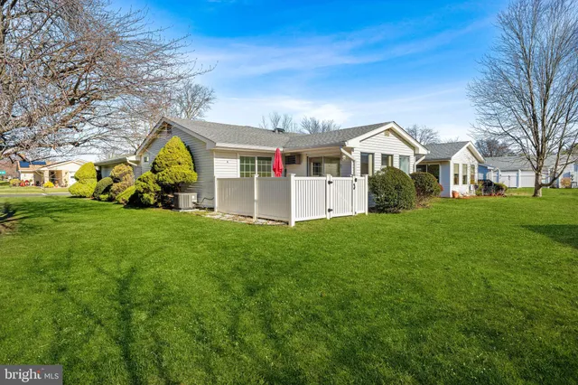 a view of a house with a yard and pathway