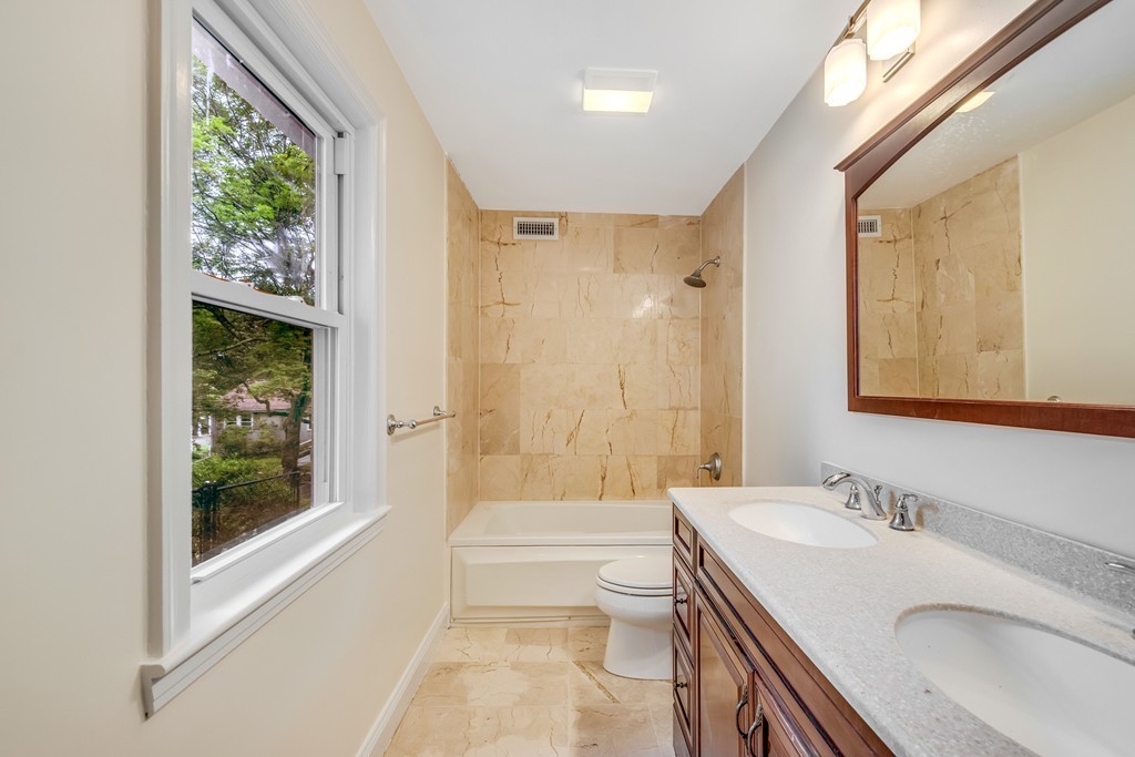 43 Kendall Road Newton, MA 02459 - Photo 15 of 22 a bathroom with a granite countertop sink toilet and shower