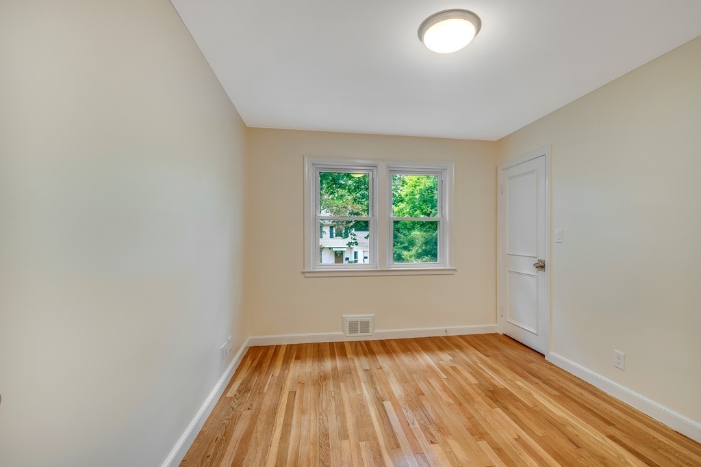 43 Kendall Road Newton, MA 02459 - Photo 16 of 22 an empty room with a window and wooden floor