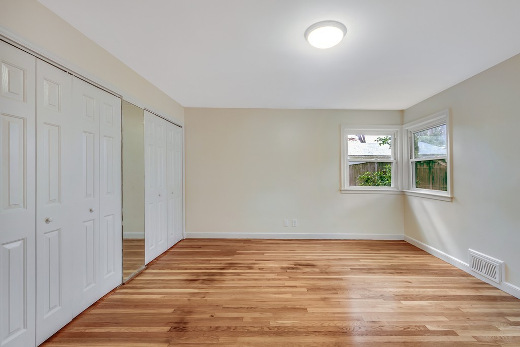 43 Kendall Road Newton, MA 02459 - Photo 18 of 22 a view of an empty room with wooden floor and a window