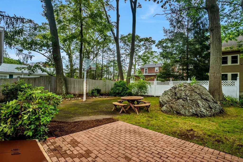 43 Kendall Road Newton, MA 02459 - Photo 2 of 22 a view of a backyard with table and chairs potted plants and large tree