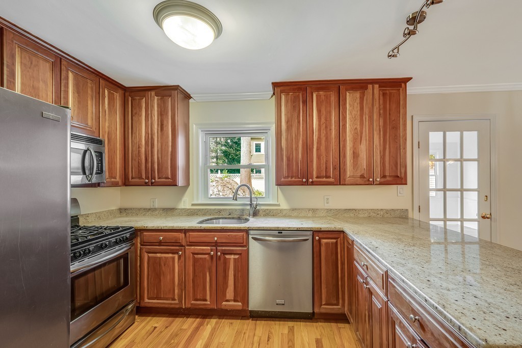 43 Kendall Road Newton, MA 02459 - Photo 8 of 22 a kitchen with granite countertop a sink a counter space appliances and cabinets