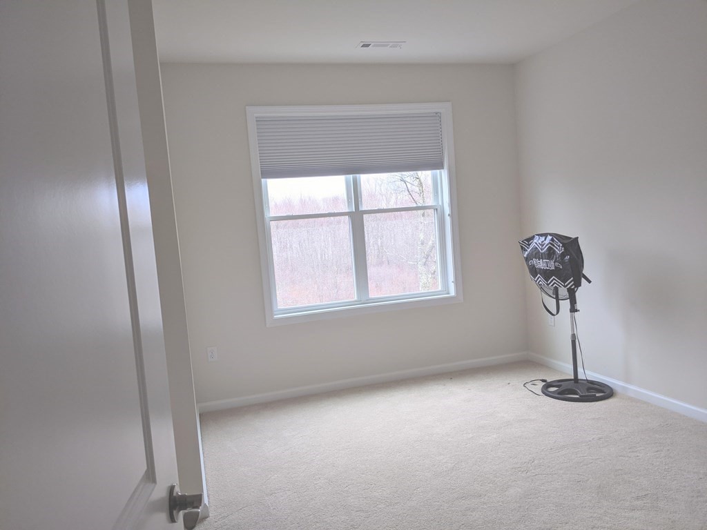 70 Trotter Road, Unit 312 Weymouth, MA 02190 - Photo 16 of 18 wooden floor in an empty room with a window