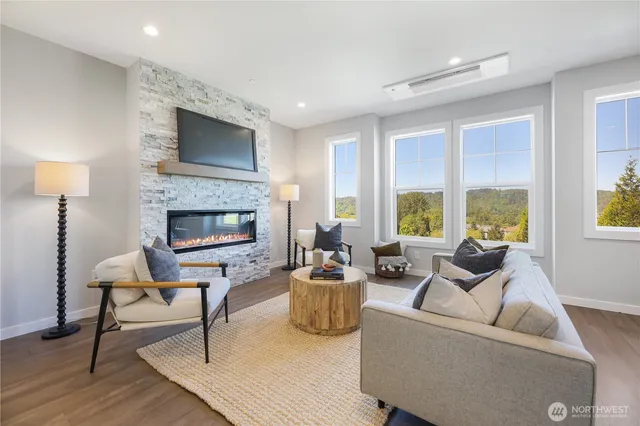 a living room with furniture a large window and a fireplace