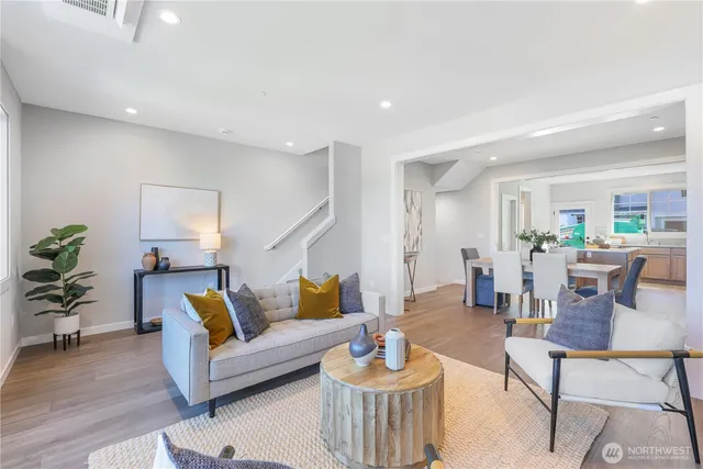 a living room with furniture and wooden floor
