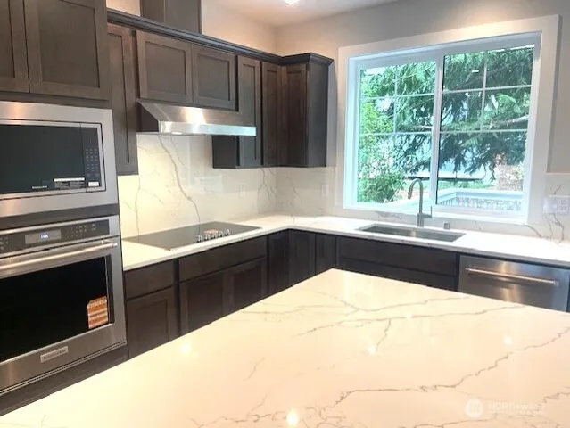 a kitchen with a sink a stove and cabinets