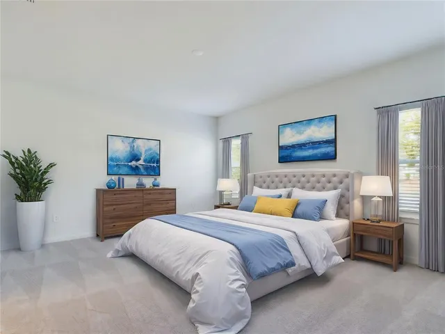 a bedroom with a large bed and a potted plant