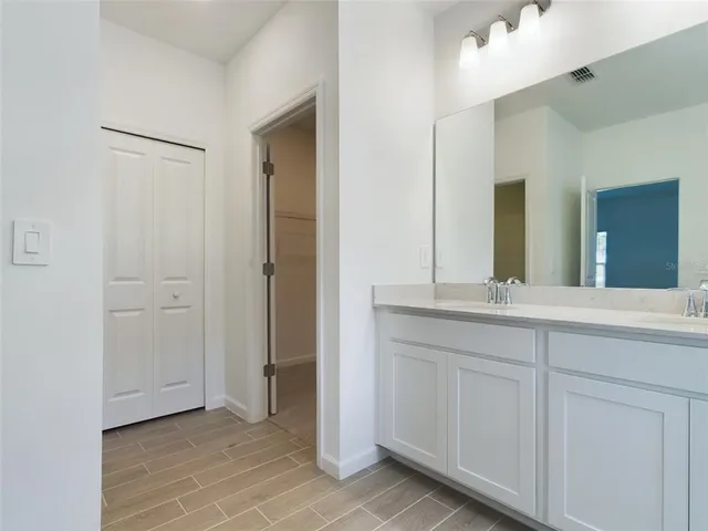a bathroom with a double vanity sink and a mirror