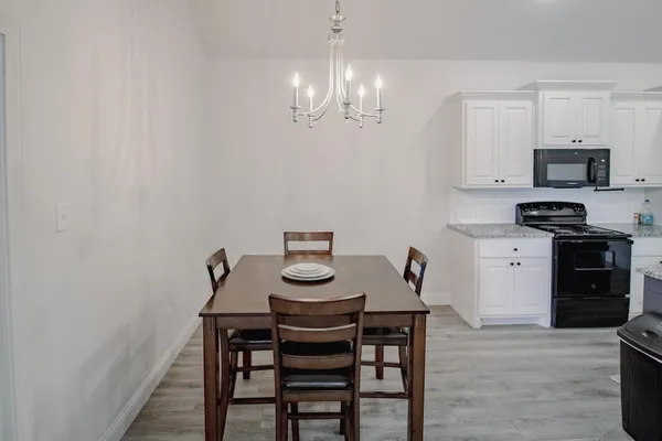 a view of a dining room with furniture and wooden floor