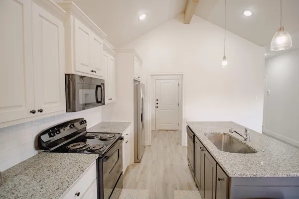 a kitchen that has a sink and a stove
