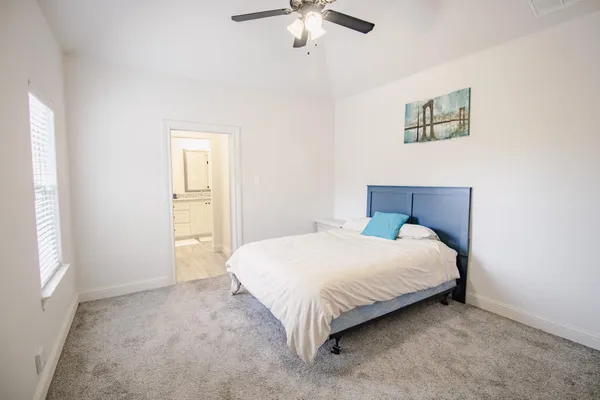 a bedroom with a bed and window