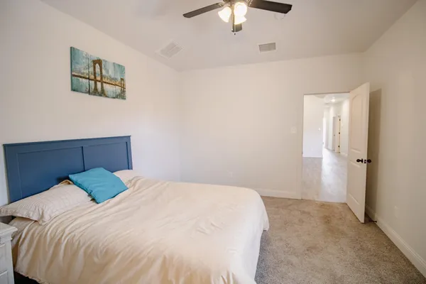a bedroom with a bed and a chandelier