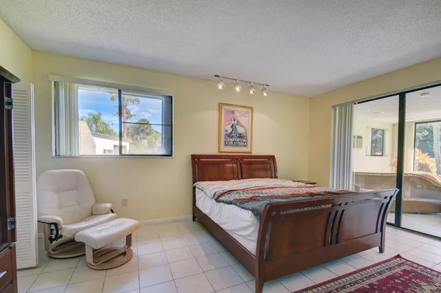 a bedroom with a bed and a chair