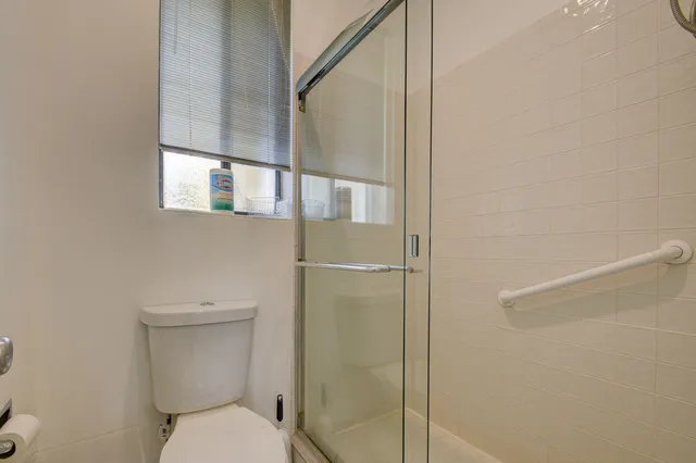 a bathroom with a toilet and a shower
