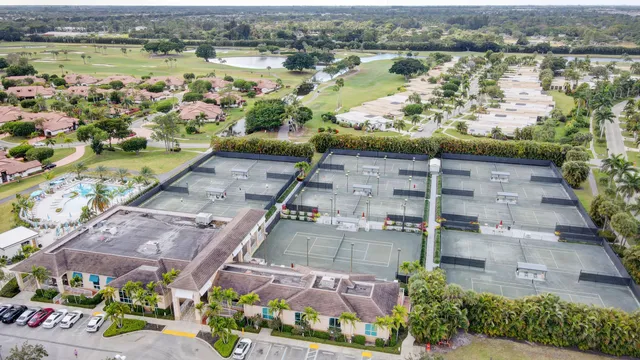 an aerial view of a residential apartment building with swimming pool and ocean view