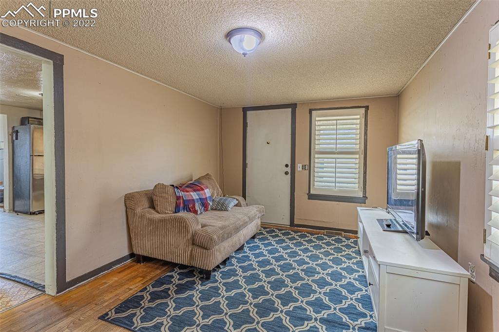 1105 Prairie Road Colorado Springs, CO 80909 - Photo 6 of 24 a living room with furniture and a window