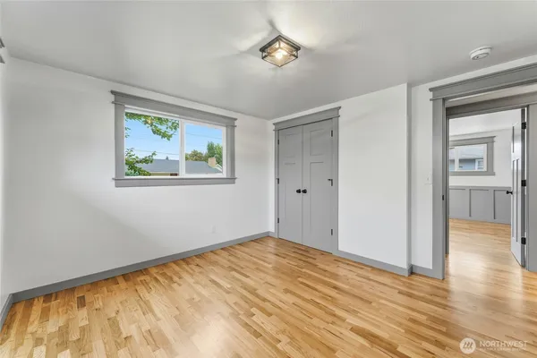a view of empty room with wooden floor