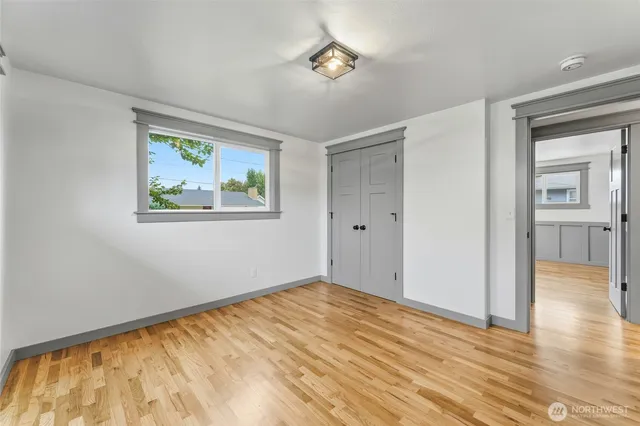 a view of empty room with wooden floor