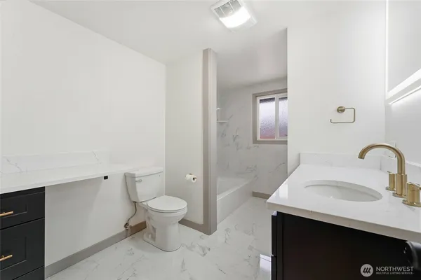 a bathroom with a sink toilet and a mirror