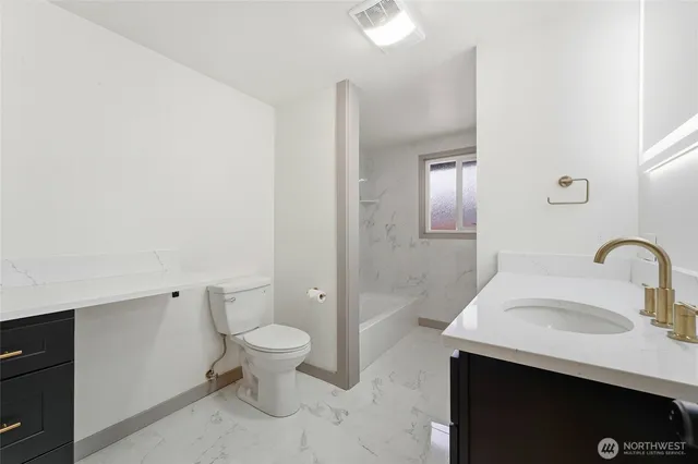 a bathroom with a sink toilet and a mirror