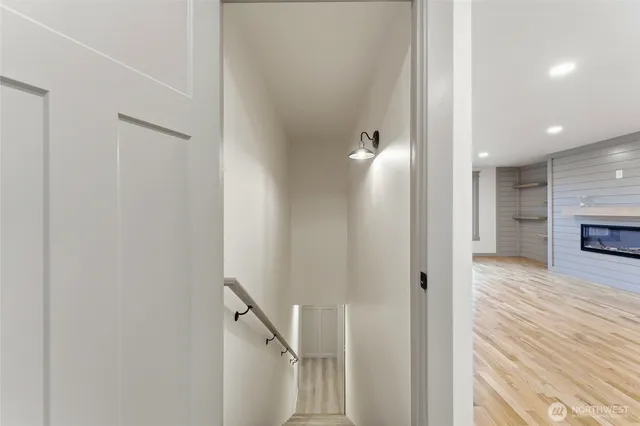 a view of a hallway with wooden floor