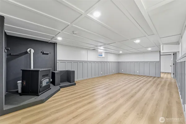 a view of empty room with wooden floor