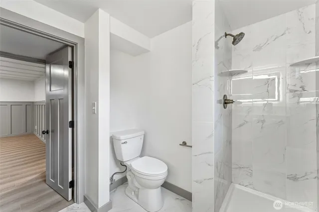 a bathroom with a toilet and a shower