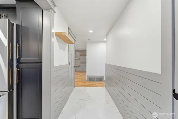 a bathroom with a glass shower door and a bathroom