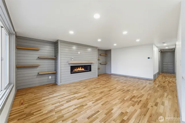 a view of an empty room and a fireplace