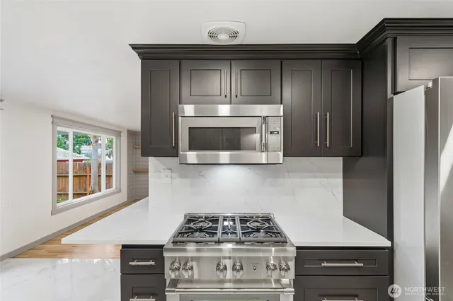 a stove top oven sitting inside of a kitchen