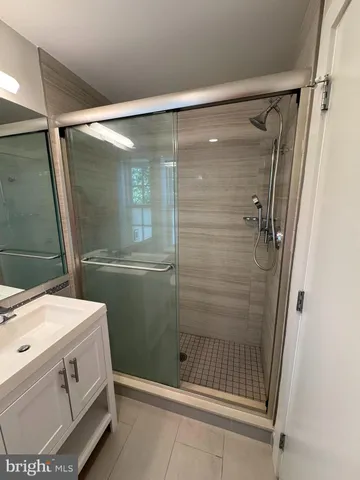 a bathroom with a shower and a sink