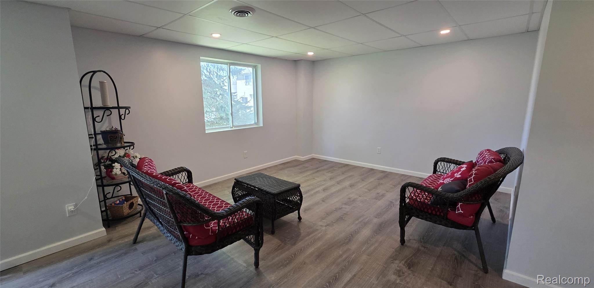 814 Nelson's Ridge Drive Howell, MI 48843 - Photo 32 of 40 Basement Family area featuring a paneled ceiling, light wood finished floors, and recessed lighting