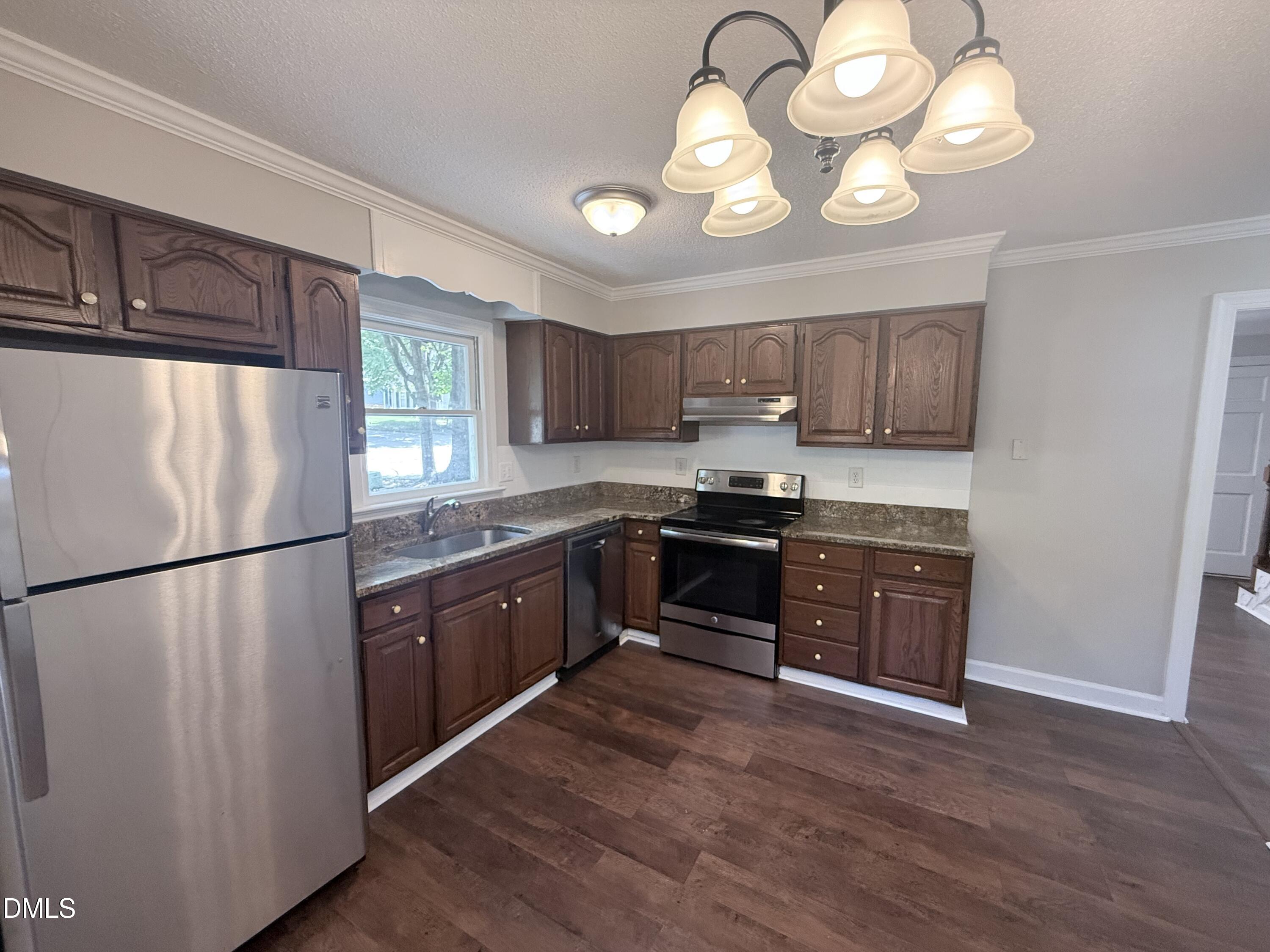 2900 Broadlands Drive Raleigh, NC 27604 - Photo 27 of 60 a kitchen with granite countertop a refrigerator stove top oven and sink