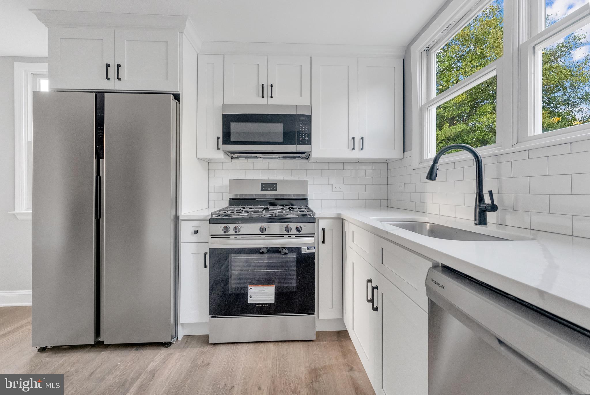 15 North Main Street, Unit A Pennington, NJ 08534 - Photo 2 of 9 a kitchen with cabinets stainless steel appliances a sink and a window