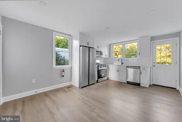 a kitchen with stainless steel appliances a refrigerator and a stove top oven