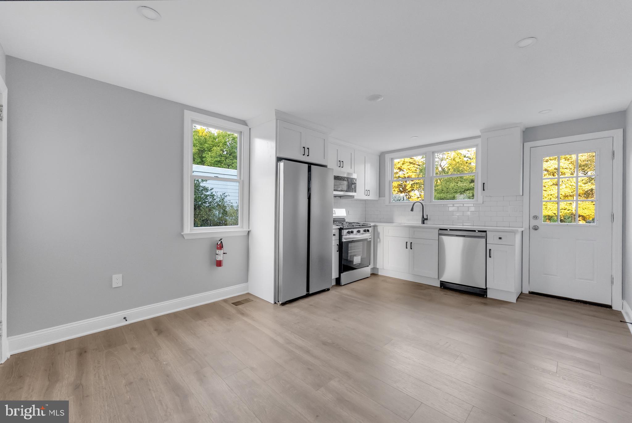 15 North Main Street, Unit A Pennington, NJ 08534 - Photo 3 of 9 a kitchen with stainless steel appliances a refrigerator and a stove top oven