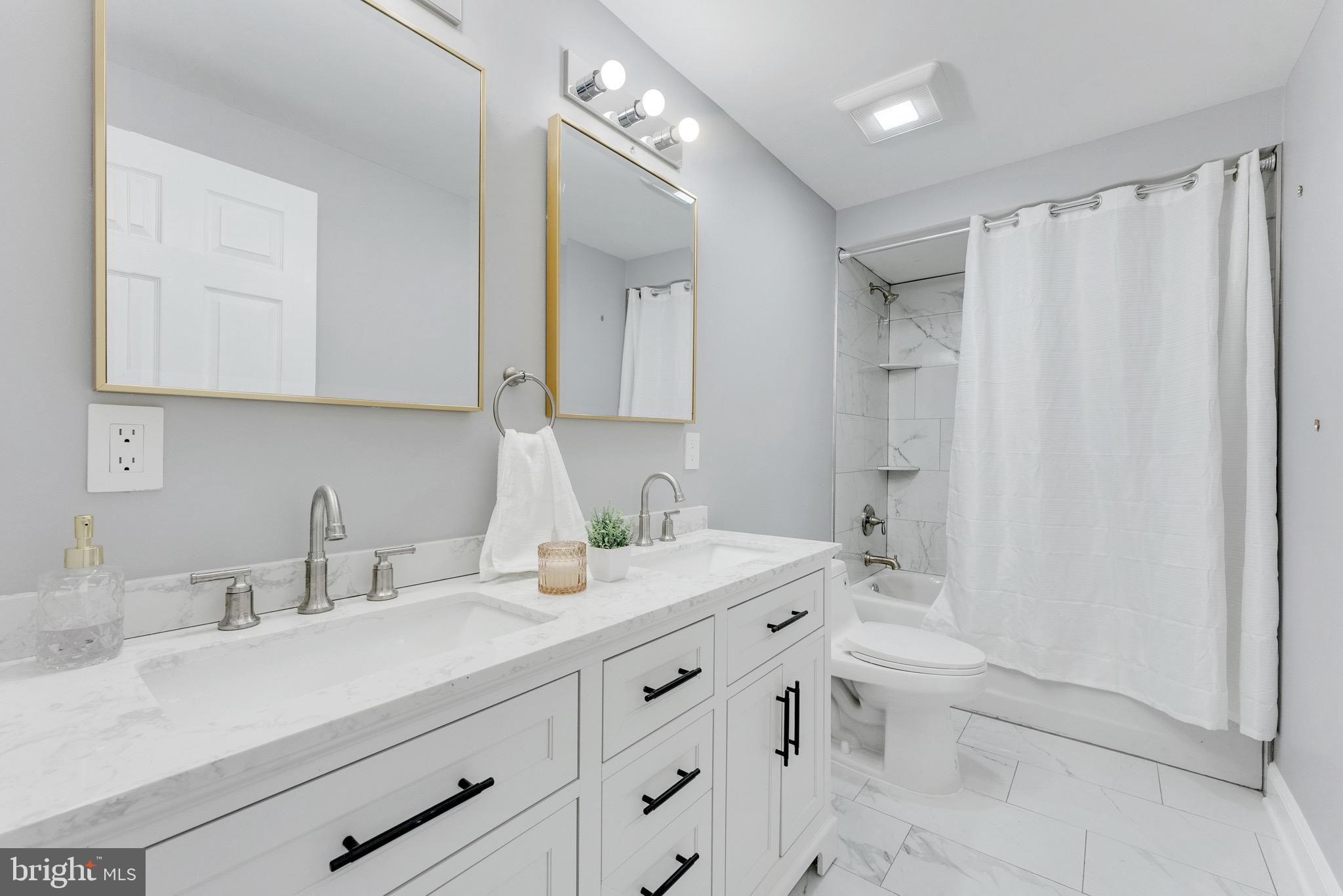 15 North Main Street, Unit A Pennington, NJ 08534 - Photo 4 of 9 a bathroom with a double vanity sink toilet and shower