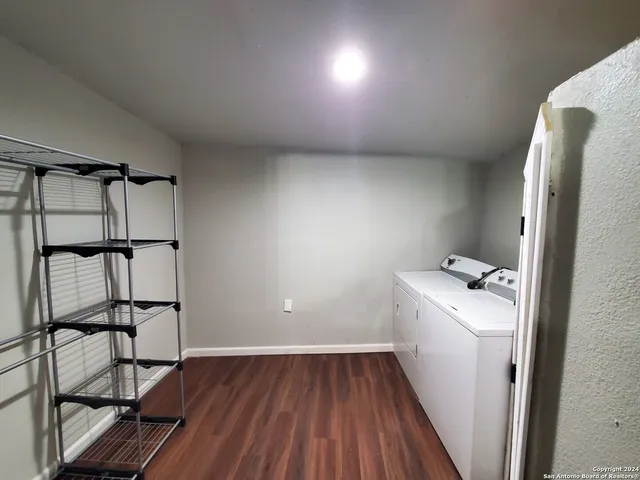 a view of a livingroom with wooden floor and a ceiling fan
